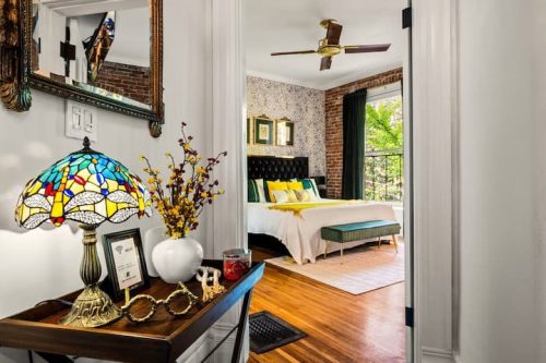 Bedroom #1 — king bed, TV, barn door, and a luxurious en-suite bathroom.